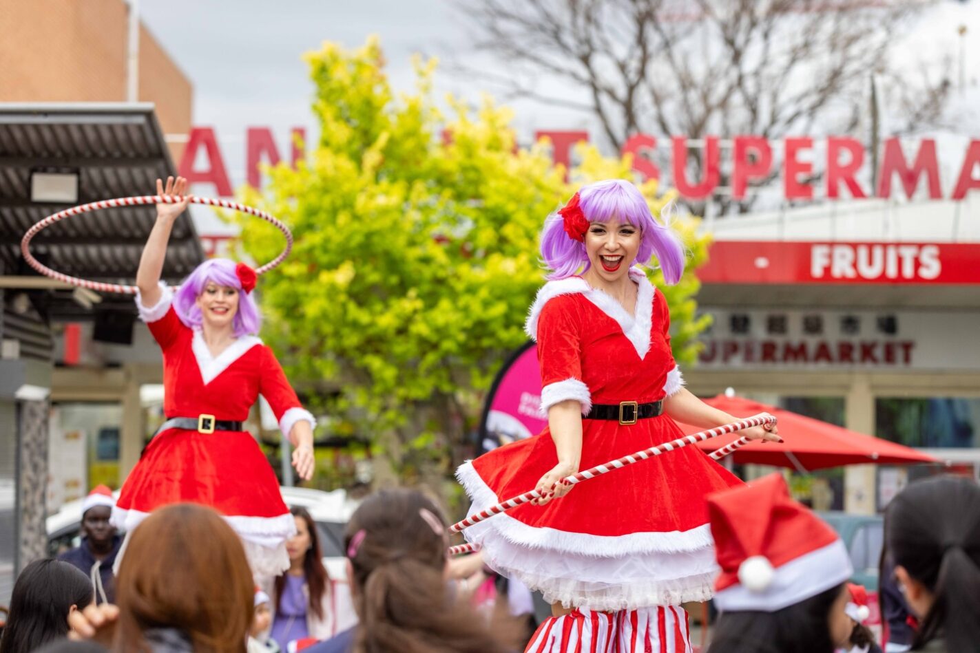 Two female performers in matching Mr